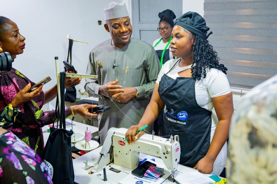 A young Nigerian entrepreneur demonstrates her tailoring enterprise at a vocational hub